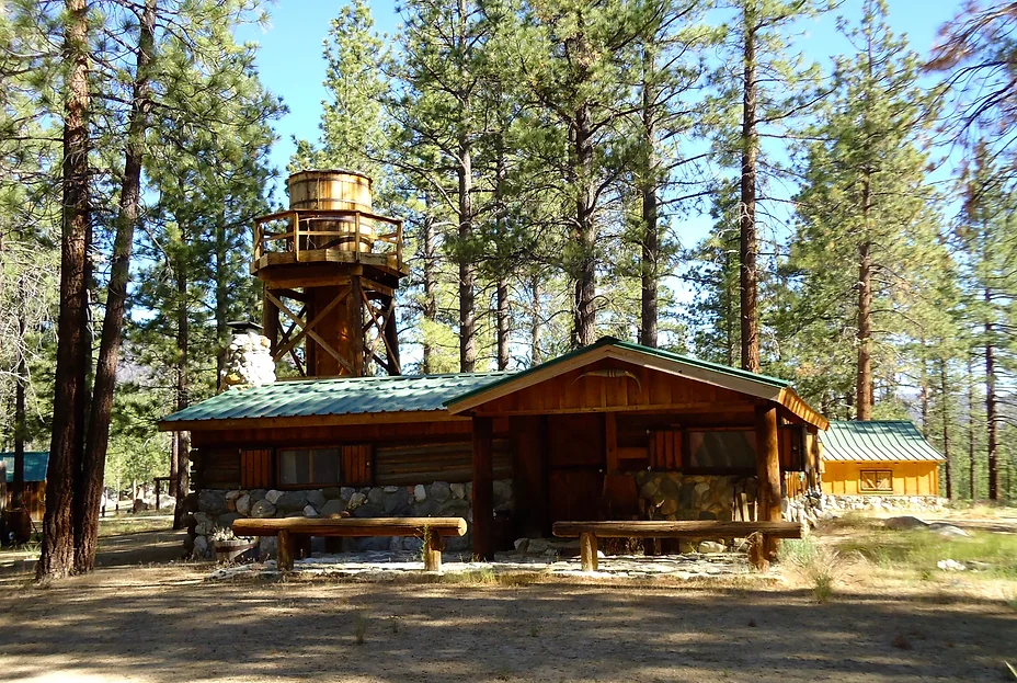 Cabin front exterior with water tower in summer
